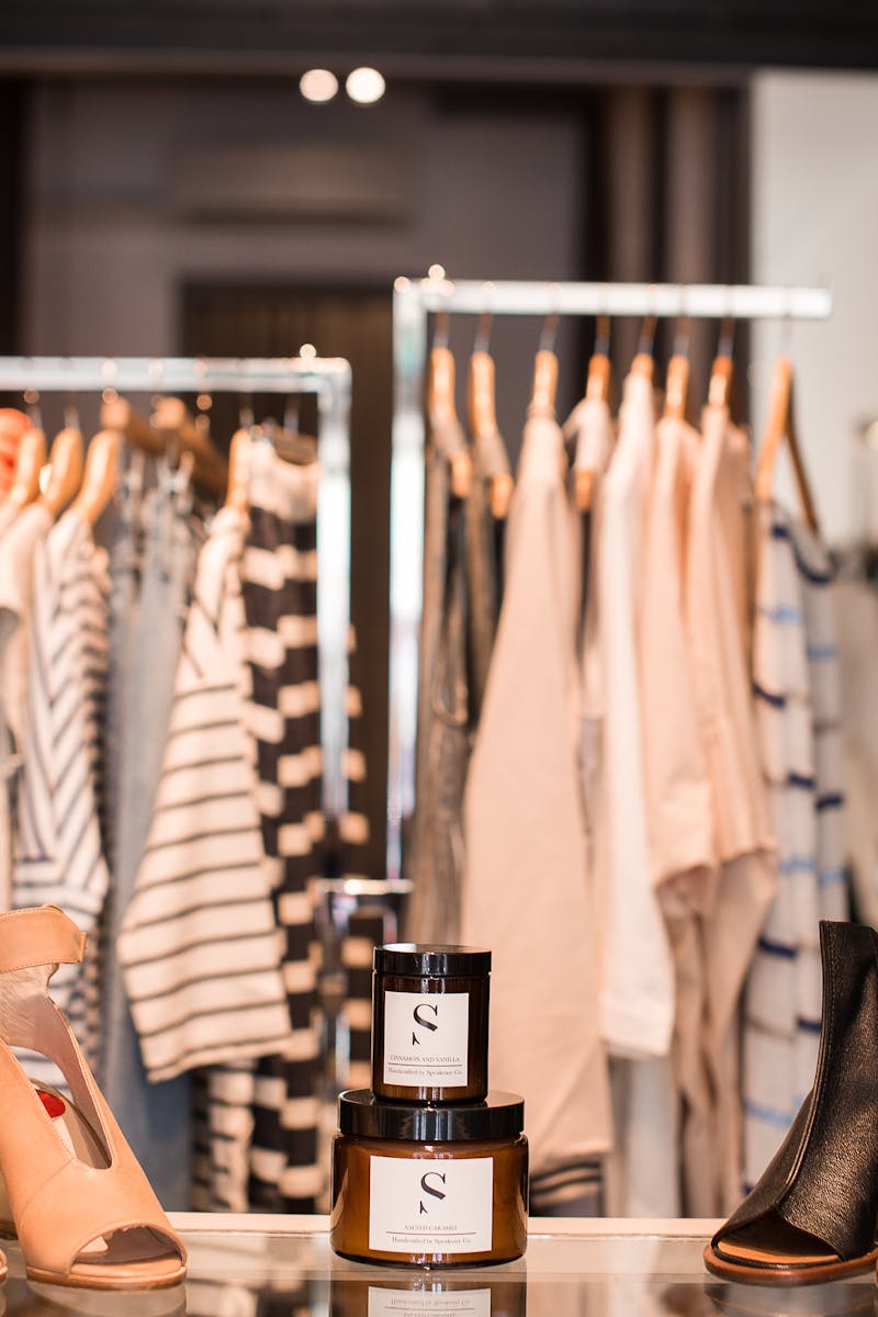 Stylish boutique showcasing clothing and footwear in a chic, modern interior.